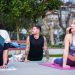 Group practicing yoga outdoors on mats in İstanbul park, embracing wellness and tranquility.